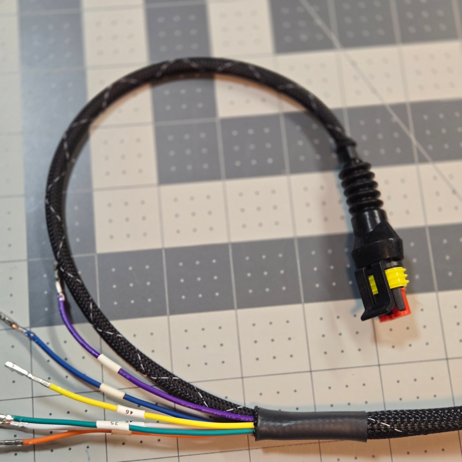 Cable with color-coded wires on a grid background